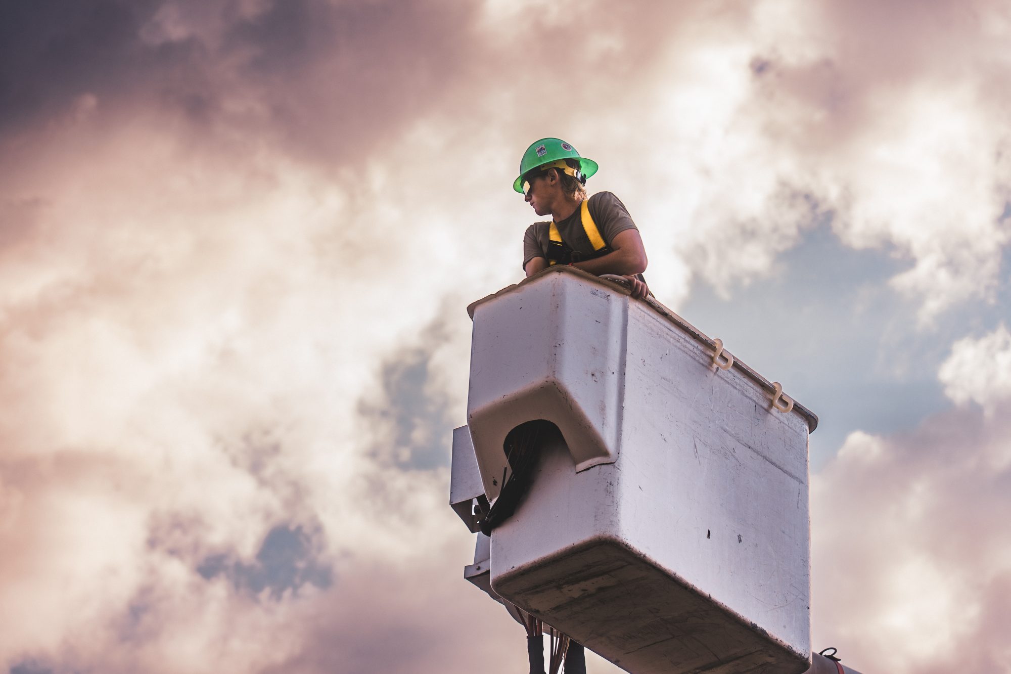 North Country lineman student climbing a utility pole